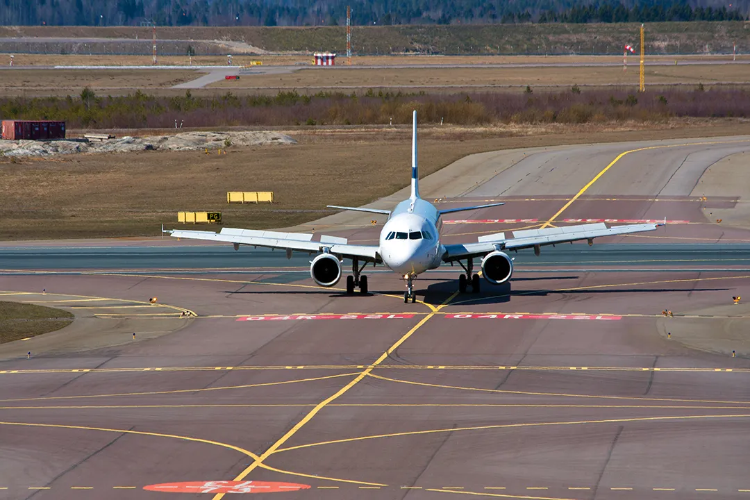 An airliner taxiing across painted ground markings, the high-risk phase the moving map set out to make safer
